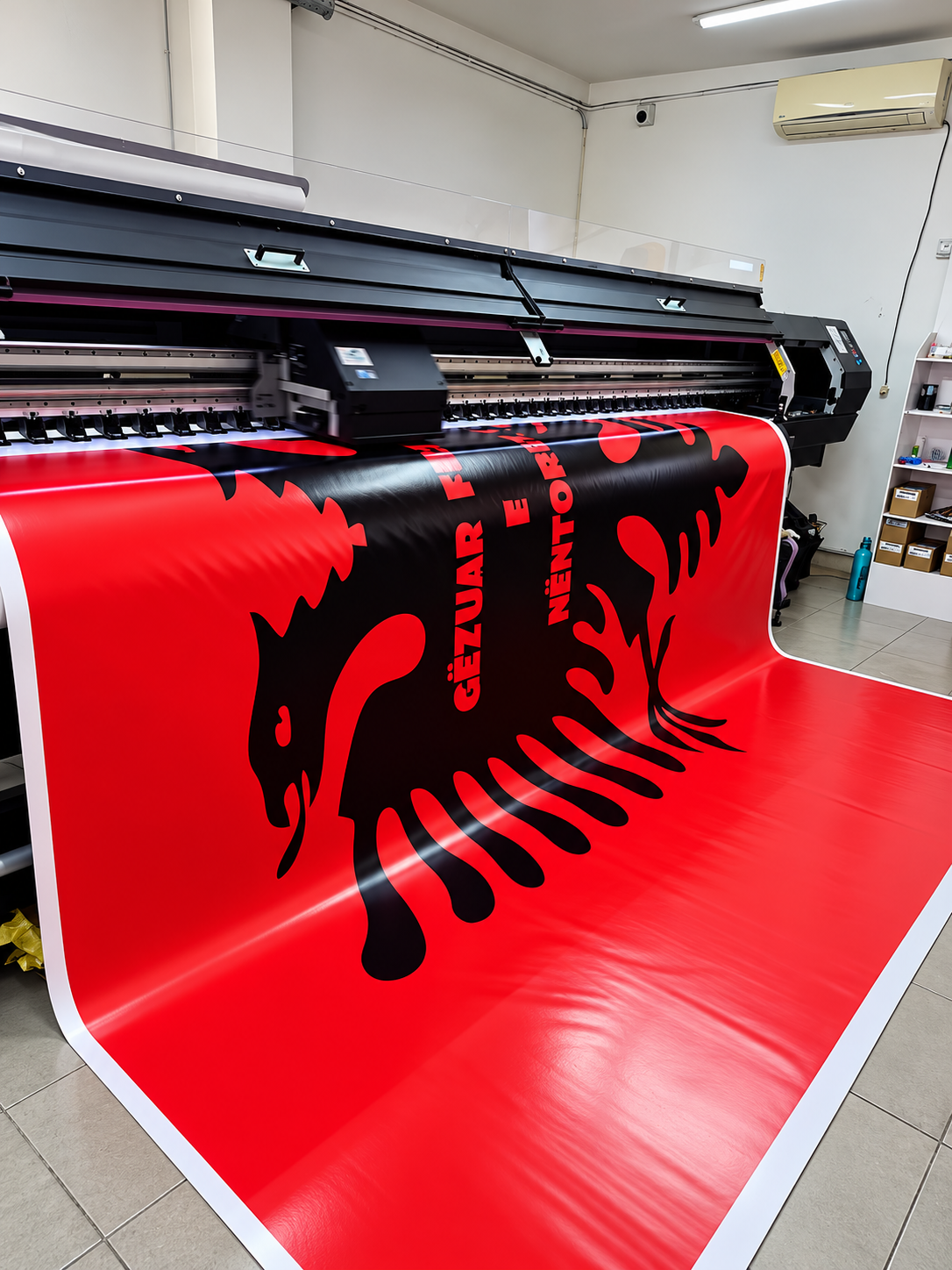industrial printer producing red eagle banner